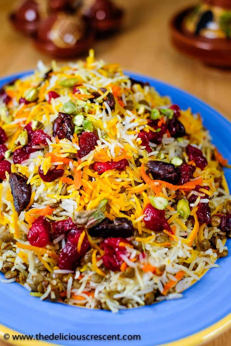 Lentils and rice with cranberries served on a plate and placed on a table