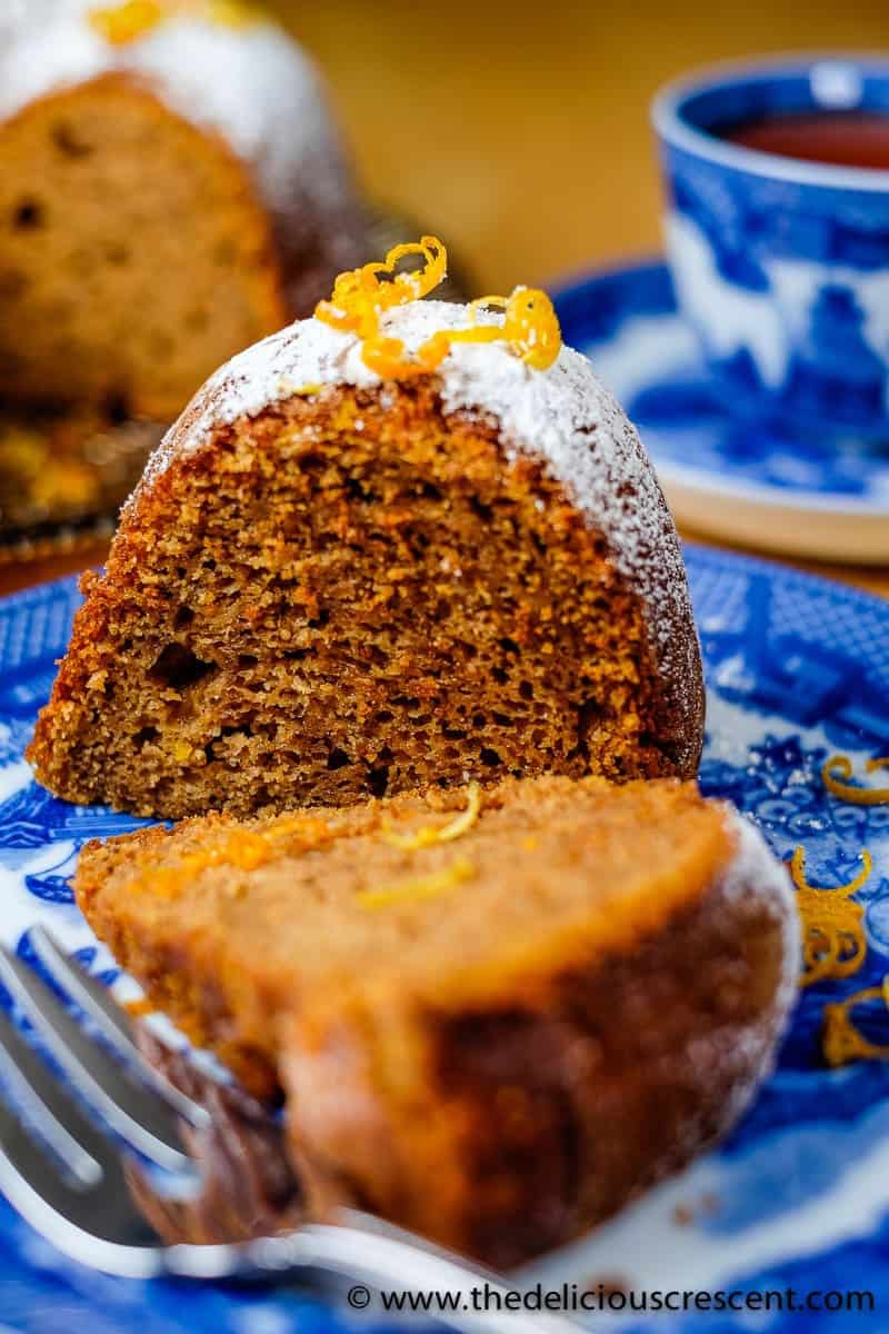 Maple sweet potato cake with walnut butter is so moist and delicious. This bundt cake is baked with walnut butter and maple syrup and packed with flavor and nutrients. Try this recipe for an amazing dessert this fall, thanksgiving and holiday season. #sweetpotatorecipes #holidayrecipe Sweet potato cake wedges placed on a blue plate.