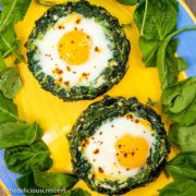 Portobello mushrooms stuffed with spinach, eggs and feta cheese, served on a plate.