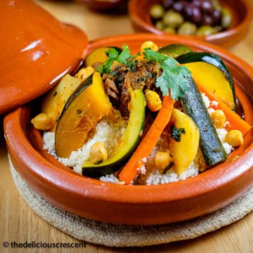 Moroccan lamb stew with cauliflower couscous served in a tagine.