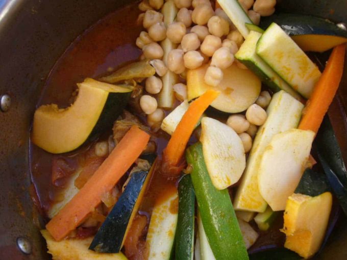 Assorted vegetables cut lengthwise and added to the cooking pot along with chickpeas.
