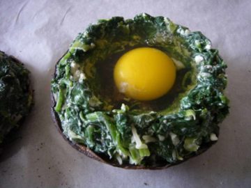 Cracked an egg into the portabello mushrooms with spinach around it.