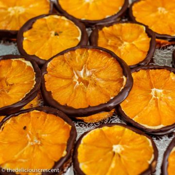 Dark chocolate orange slices arranged on a plate.