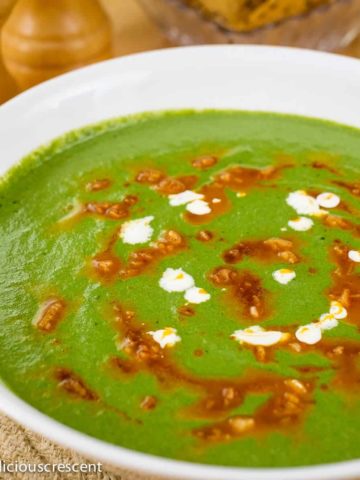 Creamy low carb spinach and mustard greens soup served in a bowl.