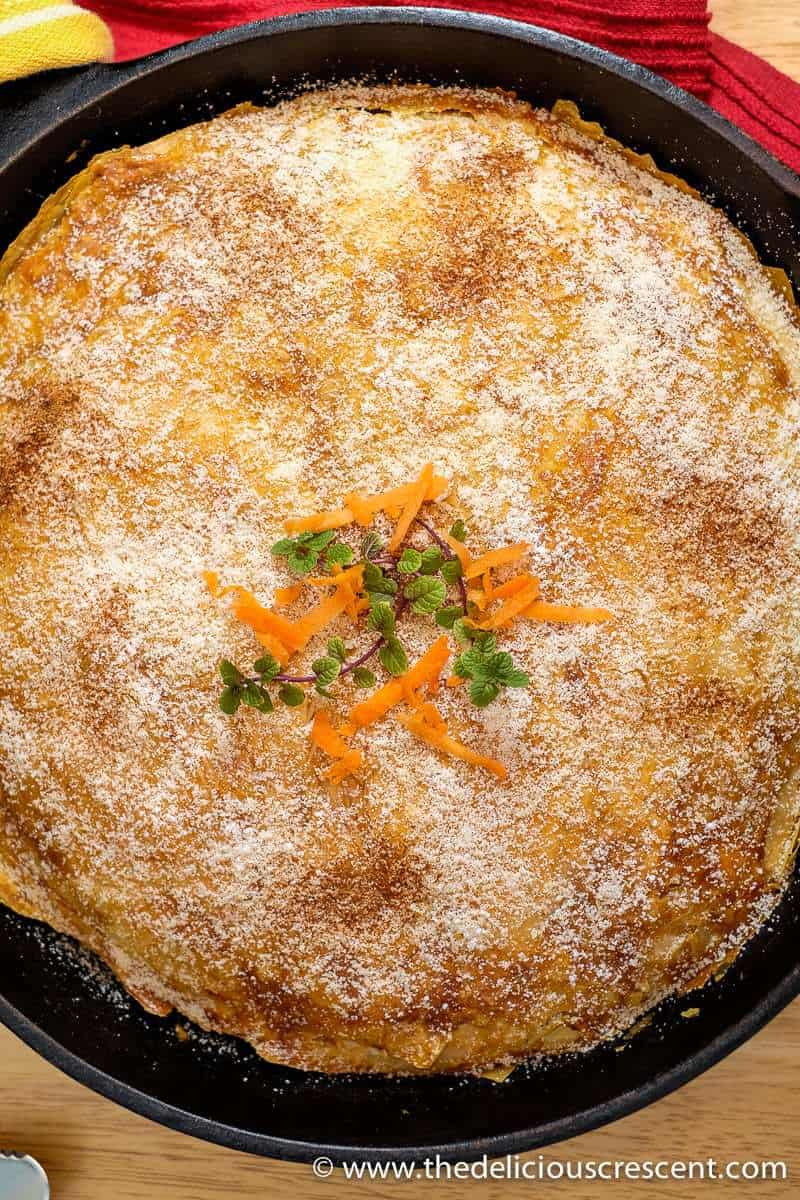 Top view of crispy pastry layers of a Moroccan bastilla.