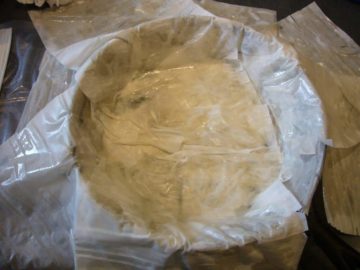 Filo dough layers, greased and layered in a round springform pan.