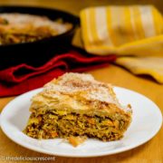 A slice of pastilla (Moroccan skillet chicken pie) served on a plate.