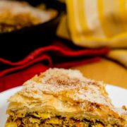 Close up view of a slice of Moroccan skillet chicken pie (pastilla).