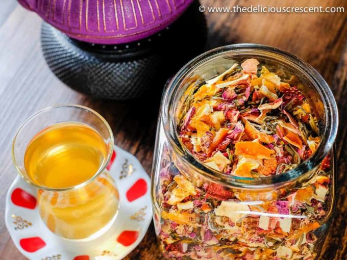 Tea infusion prepared with a homemade tea blend poured in a glass tea cup.