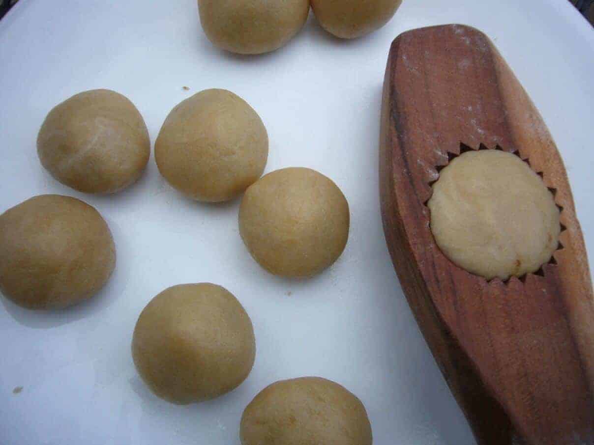 Maamoul preparation. Making a pattern on the cookies with the help of a maamoul mold.