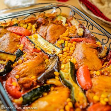 Zucchini stew with chicken (khoresht kadoo) served in a glass dish.