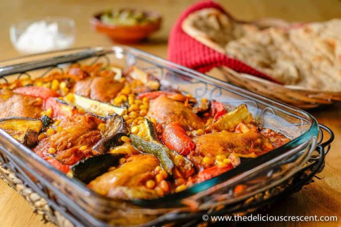 Chicken zucchini stew in a glass dish placed on the table.