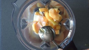 Blending cantaloupe with yogurt, rose water and honey for melon popsicles