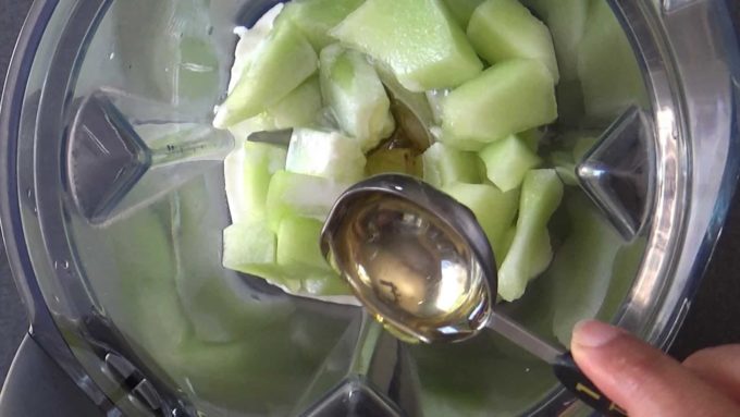 Blending honeydew melons with yogurt, rose water and honey for melon popsicles