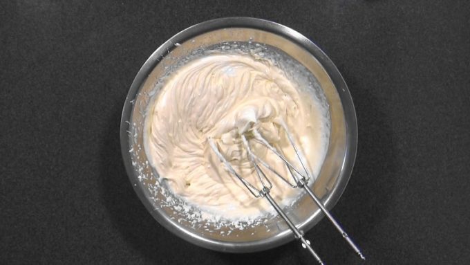 Whipping up the cream with yogurt until it is stiff