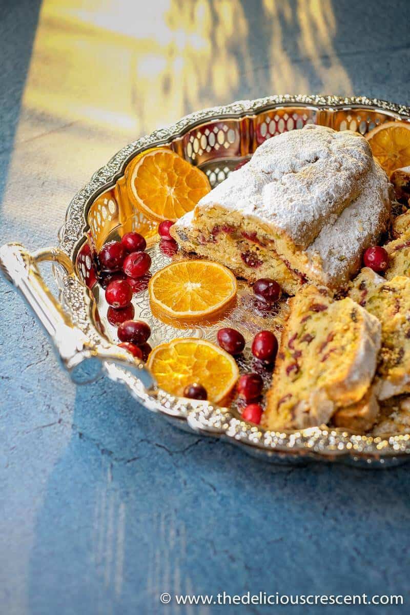 Cranberry Orange Quark Stollen with slices in a serving platter.