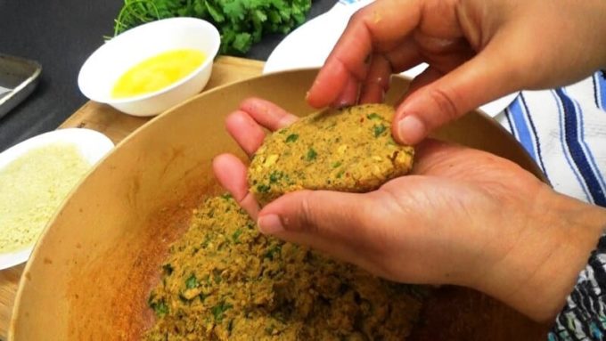 Shaping the oval spicy fish cakes (shami kabab).