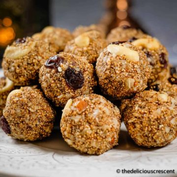 Amaranth energy balls with dates served on a plate.
