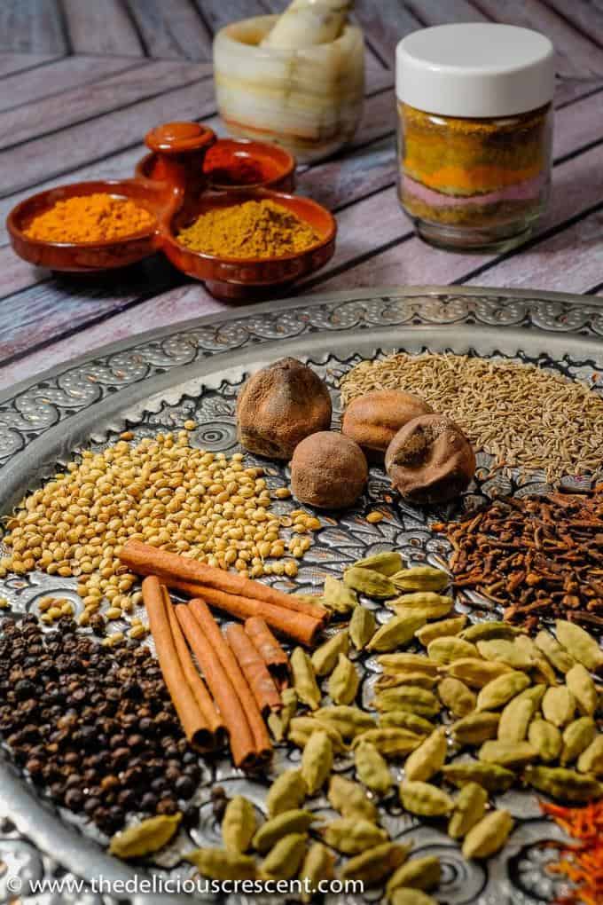 Advieh - warm, aromatic and easy homemade Persian spice mixes for spicing up all your Persian recipes. These advieh spice blend recipes are the best ever and quick to make. Easy to store and use for a variety of Iranian recipes such as rice pilafs, grilled meats, chicken, stews, vegetables, frittatas, soups, pickles and more. You may also use this vegan, gluten free, nut free and freezer friendly spice mix for other middle eastern recipes. #spice #Persianfood Assortment of spices used for preparation of advieh, the Persian spice blend.