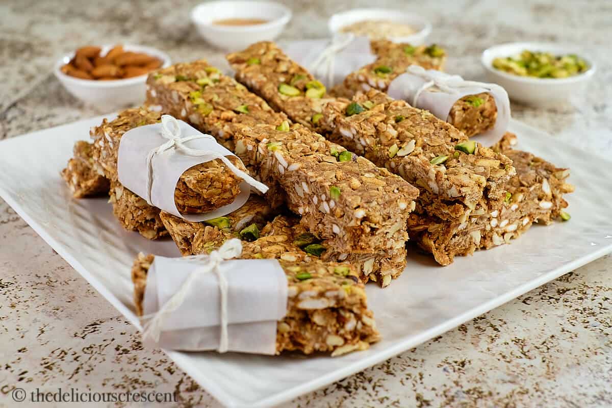 A stack of almond granola bars on a plate.