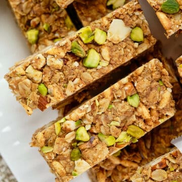 Close view of almond granola bars arranged in a white plate.