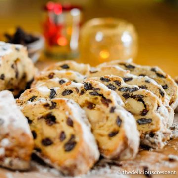 Classic German stollen sliced and served on a wooden board.