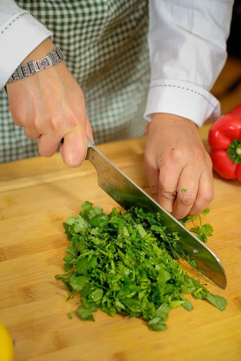 Chopping fresh herbs to make salad.
