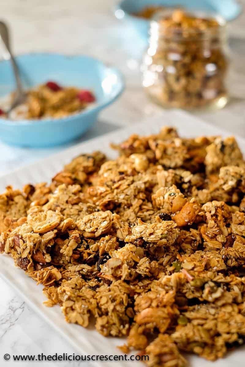 Close up view of baked oat clusters served in a white plate.