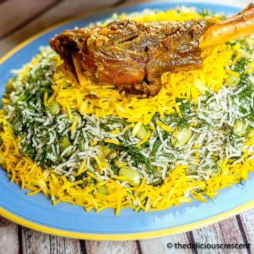 Baghali polo (dill rice with lima beans) served with a lamb shank on a plate.