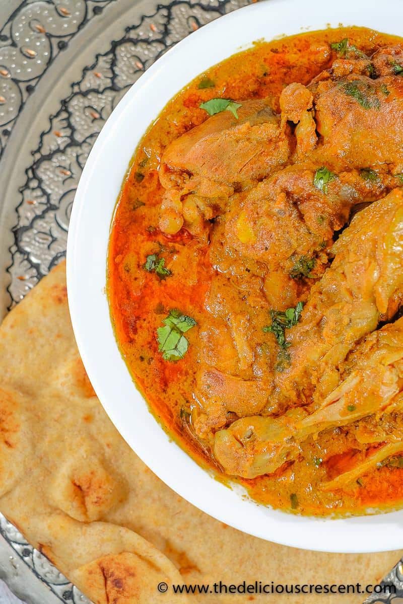 Chicken cooked in a spiced yogurt gravy and served with flatbread.