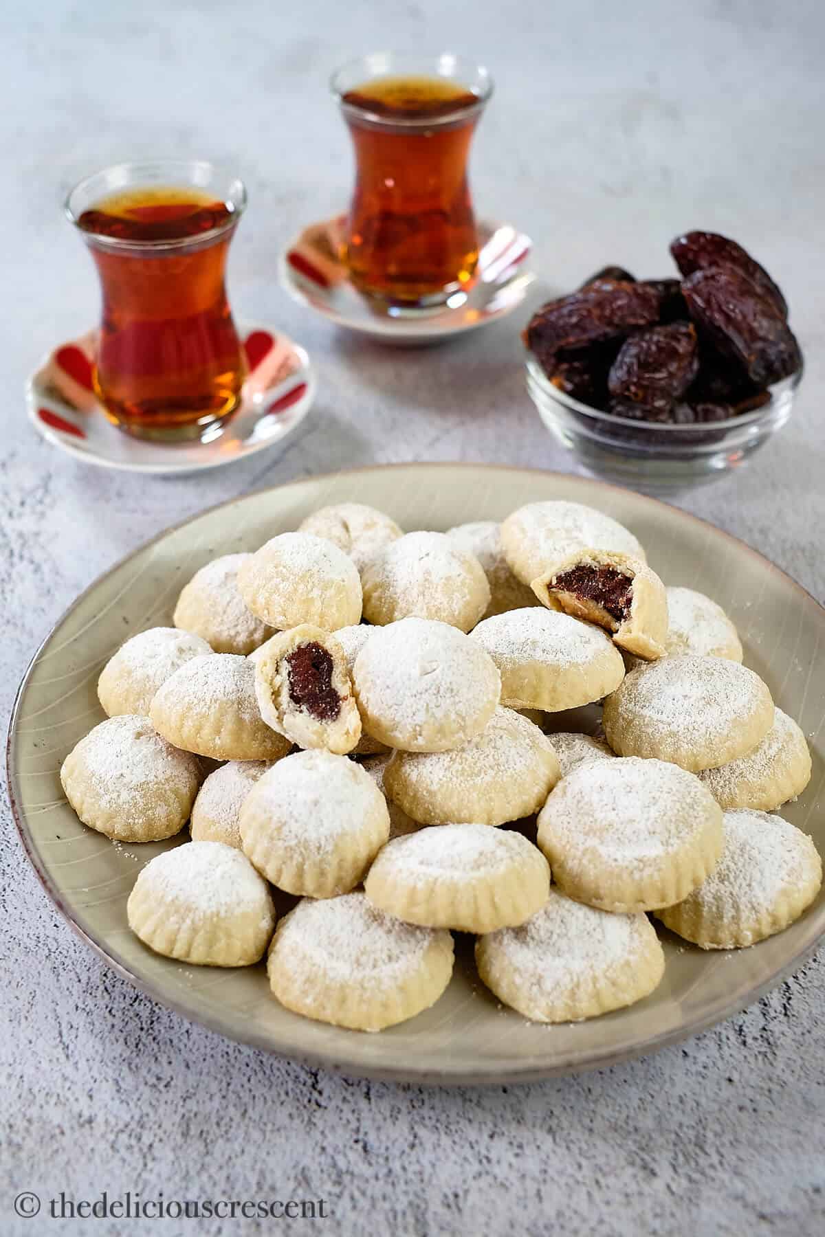 Middle eastern date-filled cookies arranged in a plate.