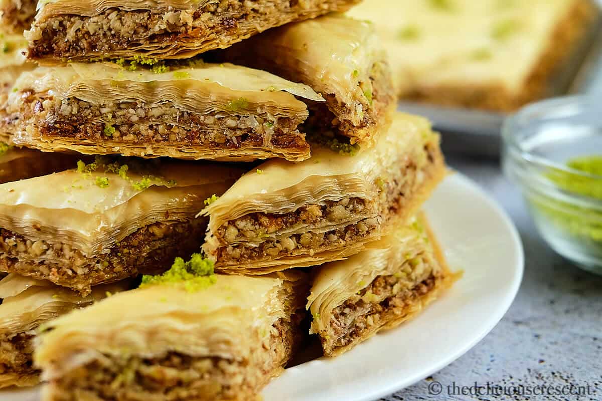 A stack of baklava pieces served on the table.