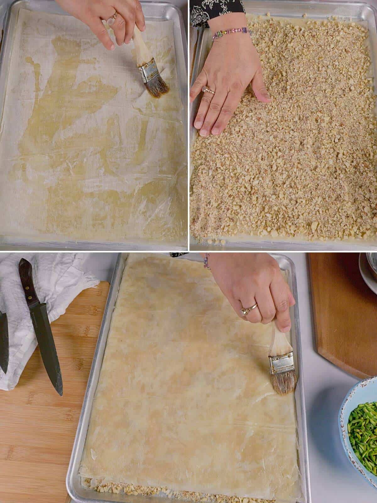 Pastry being assembled by brushing phyllo sheets with ghee and layering with nuts.