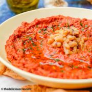 Muhammara served in a bowl with extra olive oil.