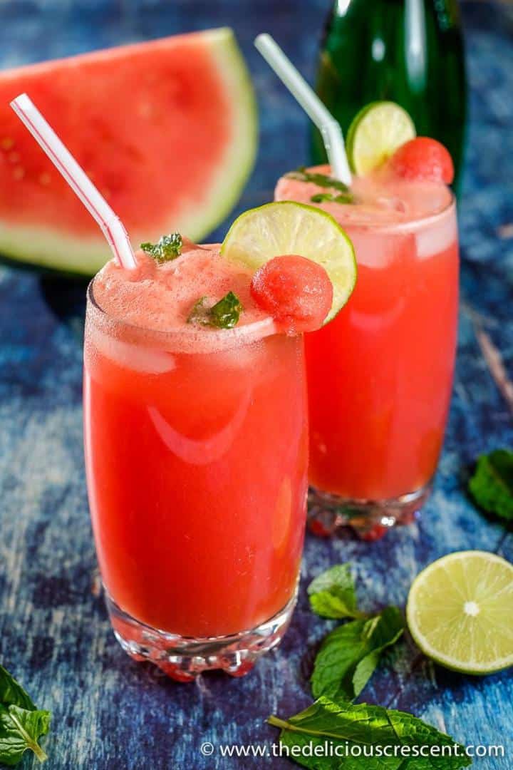 Glasses full of watermelon juice with mint and lime.