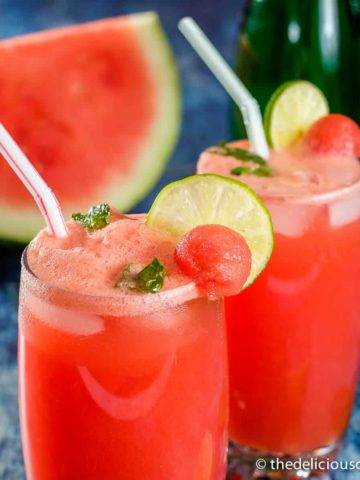 Watermelon juice with mint and lime slices served in glasses.
