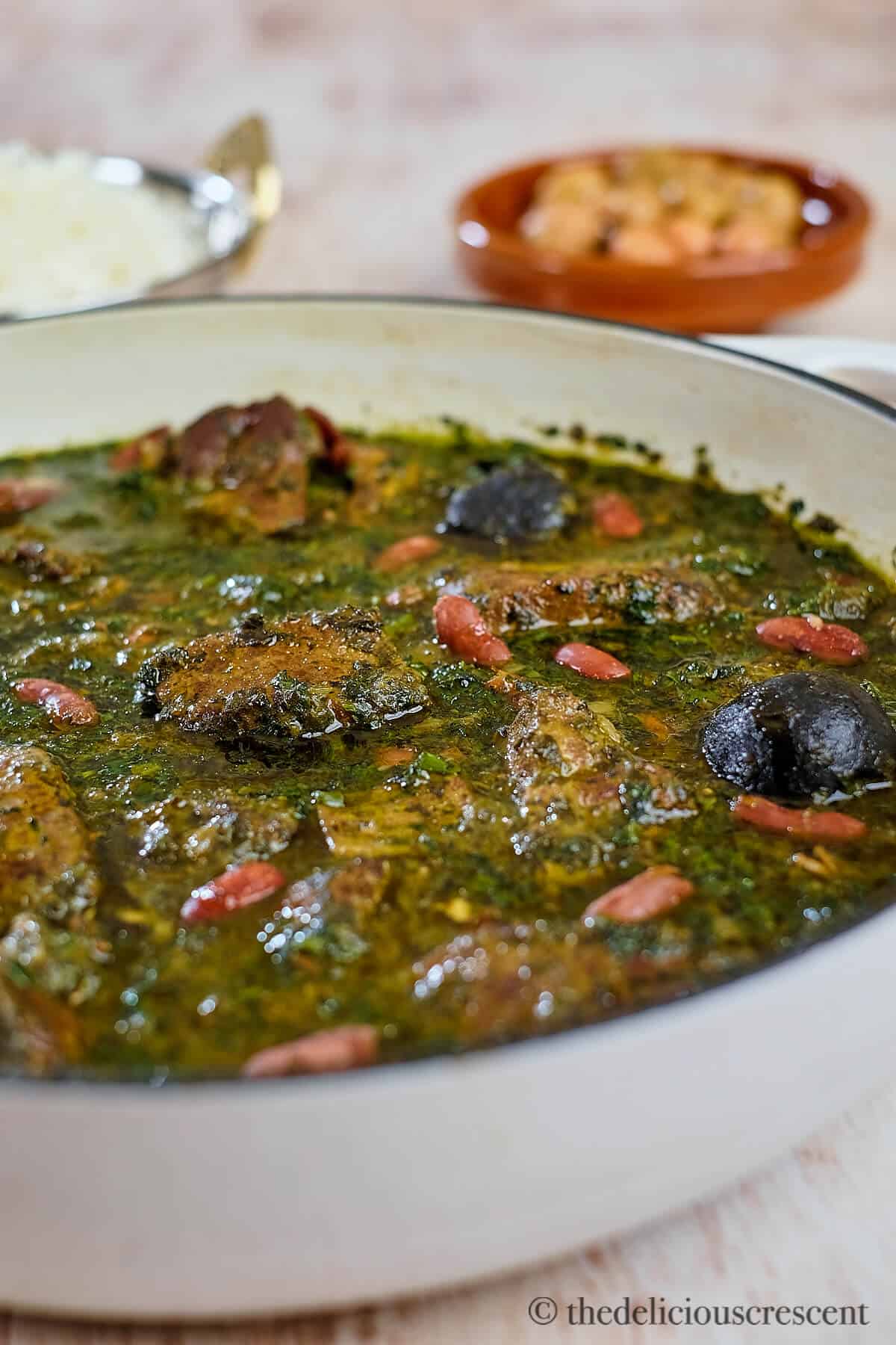 Persian herb stew in a white pan.