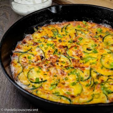 Persian zucchini frittata baked in a cast iron skillet.