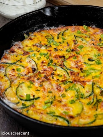 Persian zucchini frittata baked in a cast iron skillet.