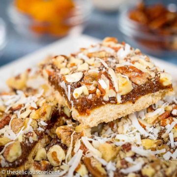 Date bar cookies served on a white plate.