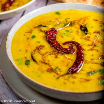 Indian dal served in a bowl with bread.