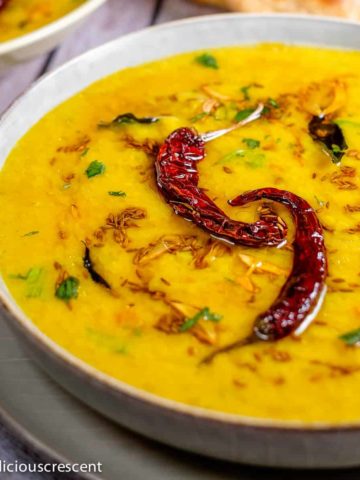 Indian dal served in a bowl with bread.