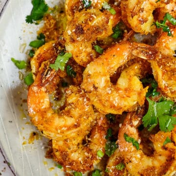 Close up view of sauteed spicy shrimp served in a plate.