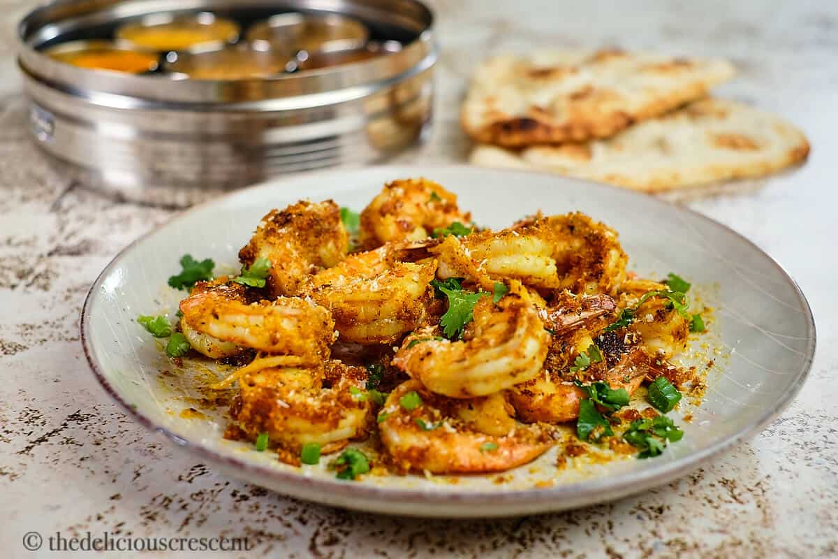 Front view of sauteed spicy shrimp on the table.