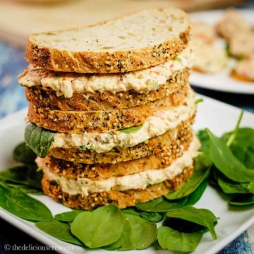 Tuna sandwiches made with chipotle stacked on a plate.