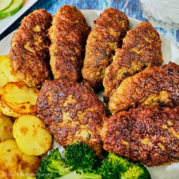 Persian meat patties with potatoes on a plate.