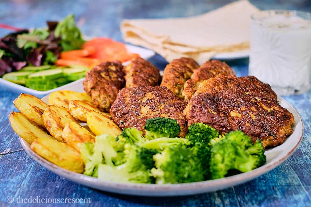 Ground lamb patties served on a plate.