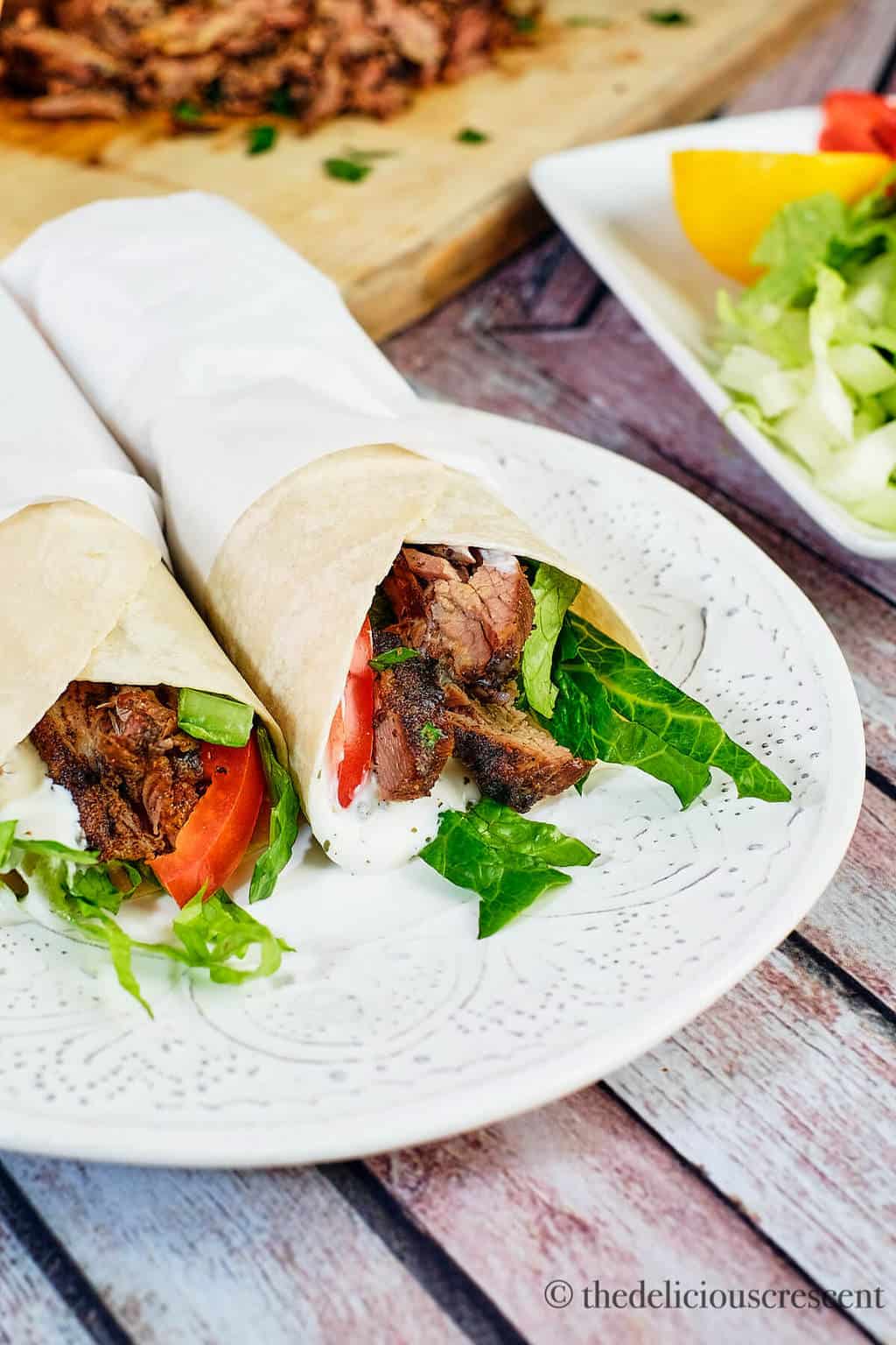 Close up view of wraps with roasted meat and vegetables.