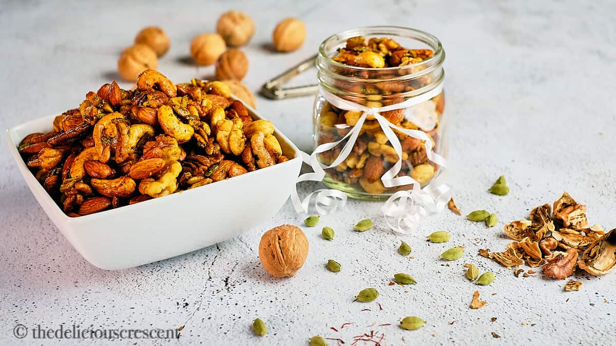 A distant view of spiced and roasted almonds, cashews, pecans and walnuts.