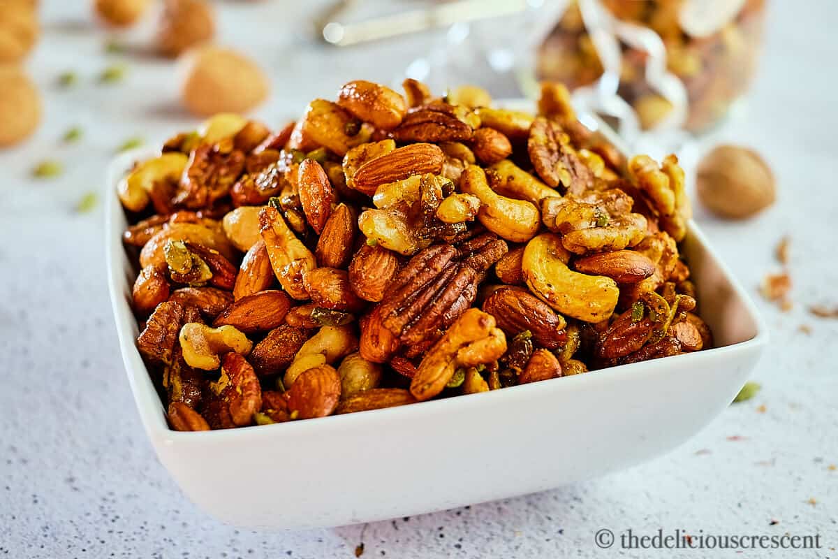 A bowl full with nuts roasted with cardamon, saffron and maple syrup.